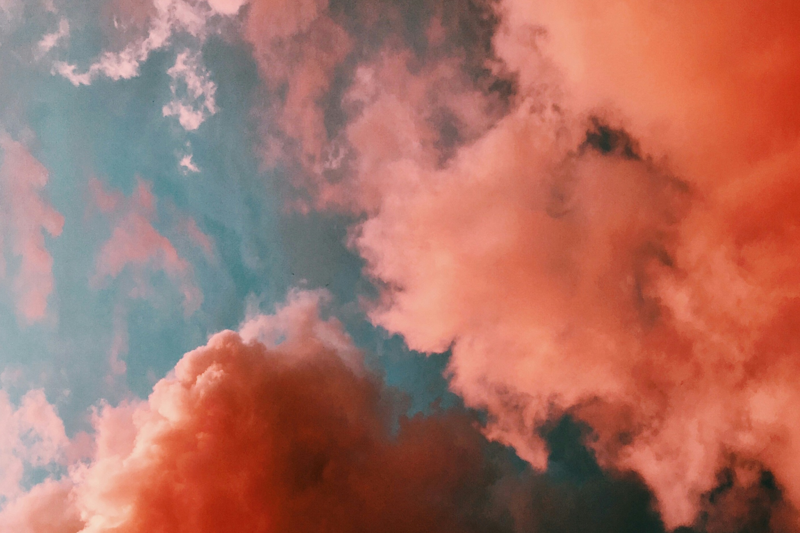 Fluffy clouds tinged pink by the sunset